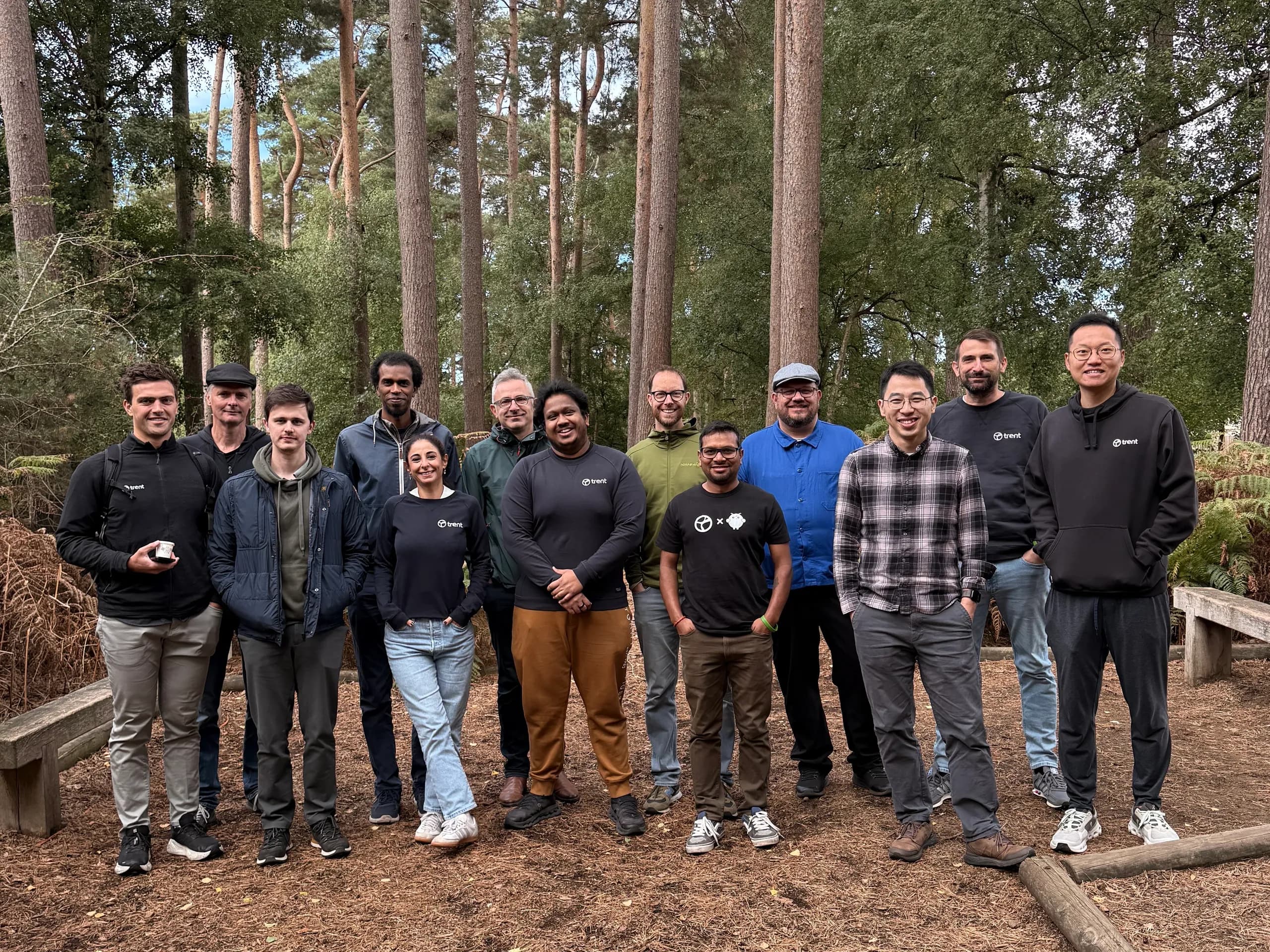 The Trent AI team, standing together outdoors among tall pine trees.